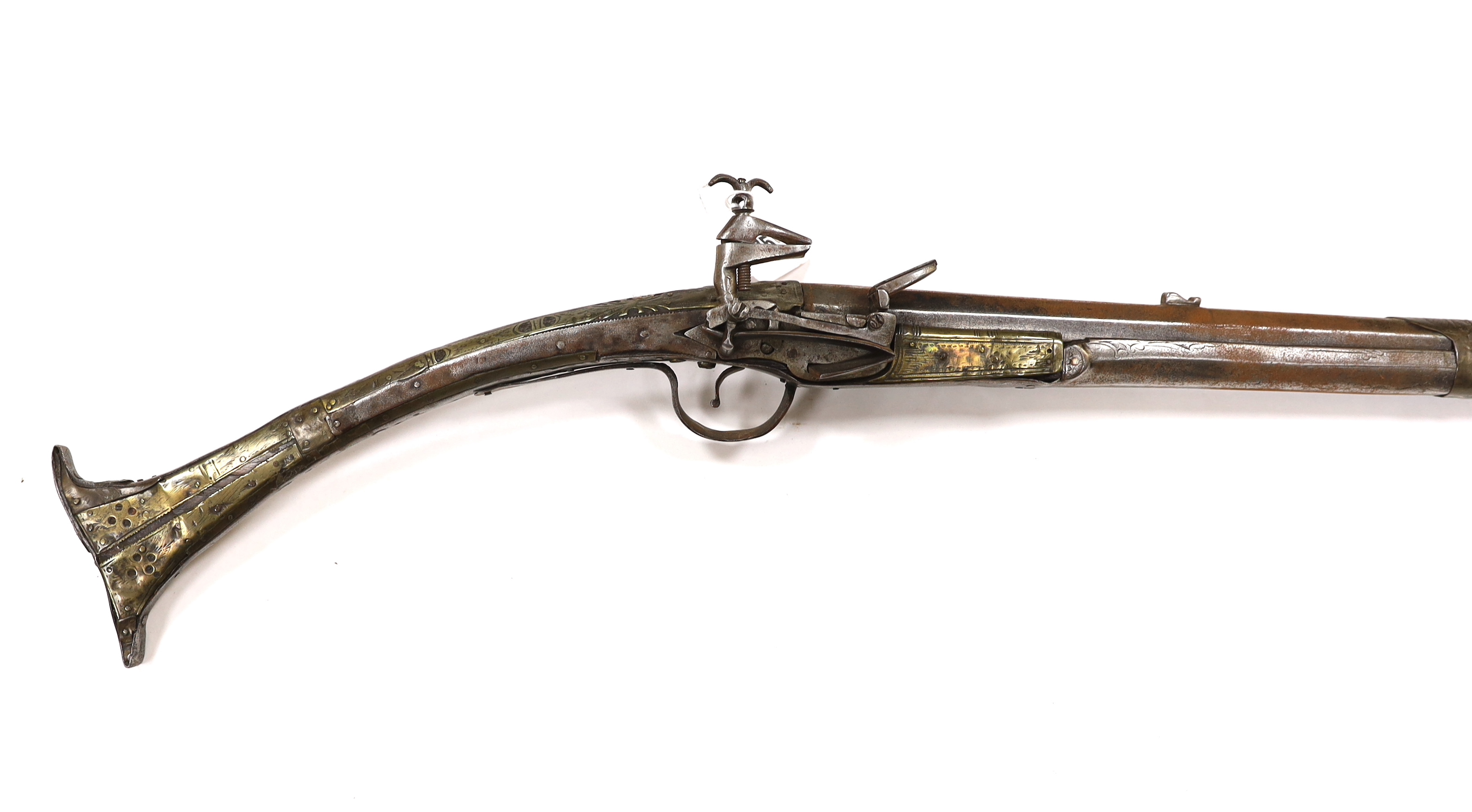 A 19th century Albanian flintlock miquelet lock rifle (Balkan long arm) and a Caucasian style dagger, with niello work scabbard, barrel 122cm (2)